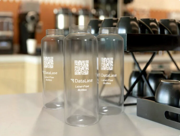 Screenshot 2026-02-23 at 5.02.35 PM DataLase has introduced a white coating that can be sprayed onto plastic bottles on high–speed lines and then finely imaged using various lasers producing a high opacity white image on a clear background Image Data Lase