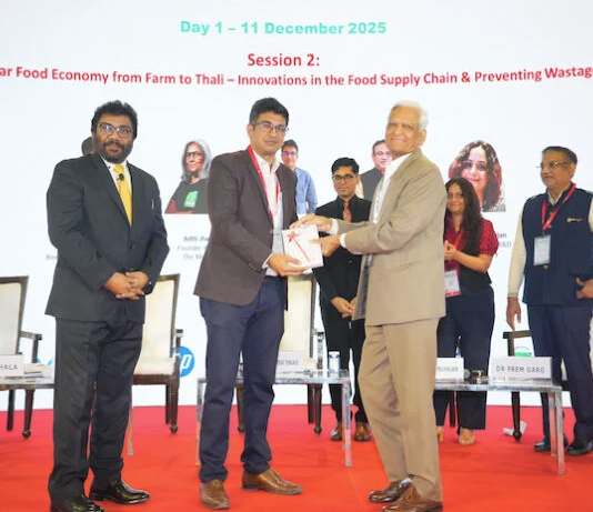 Vijay Sood presents a momento to Nitin Sanduja of Buhler India alongside the Intrapack exhibition at the first FoodTekPack Conference on 11 December 2025 at the Greater Noida Expo. Standing to their left is Ainan Shahidi. Behind them on the stage, from left to right, are Aditi Jhala, Bhushan Yengade, Himanshi Mahajan, and Sandeep Ghosh Photo PSA/IPAMA